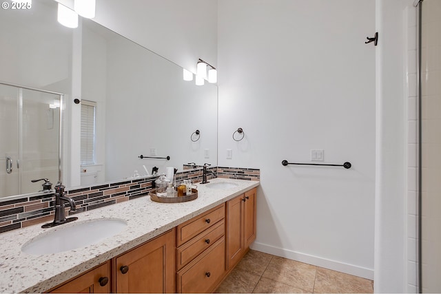 bathroom featuring tasteful backsplash, tile patterned floors, an enclosed shower, and vanity