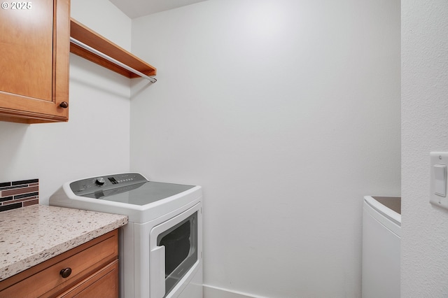 laundry area featuring cabinets and washing machine and dryer