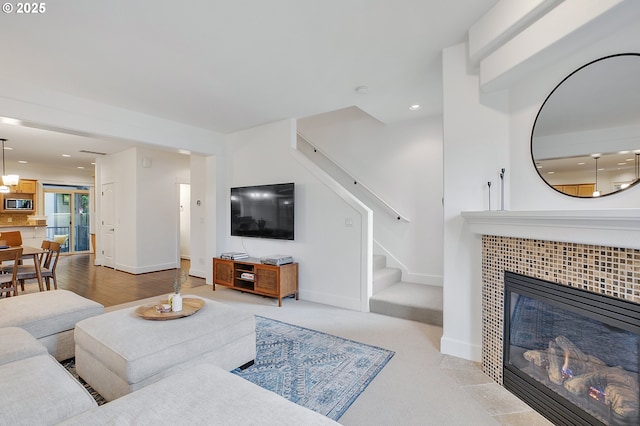 living room with a tile fireplace