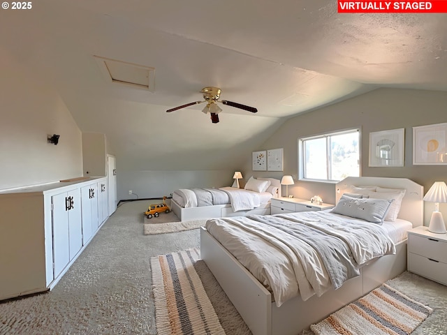 1042 Fir Ave, Reedsport, OR 97467 - bedroom featuring lofted ceiling, carpet floors, a ceiling fan, and attic access