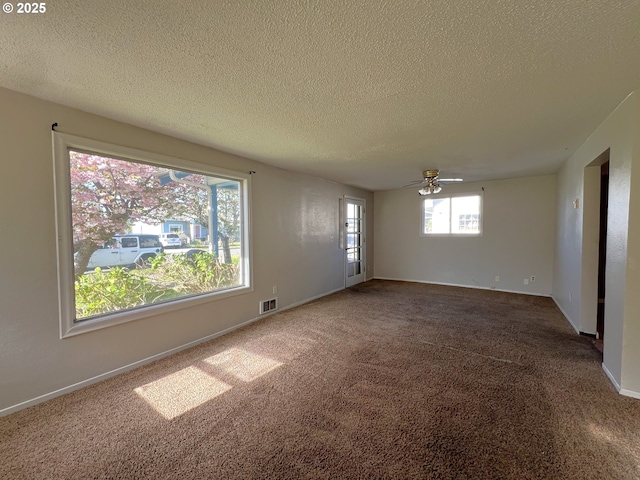 1042 Fir Ave, Reedsport, OR 97467 - carpeted empty room featuring a textured ceiling and a ceiling fan