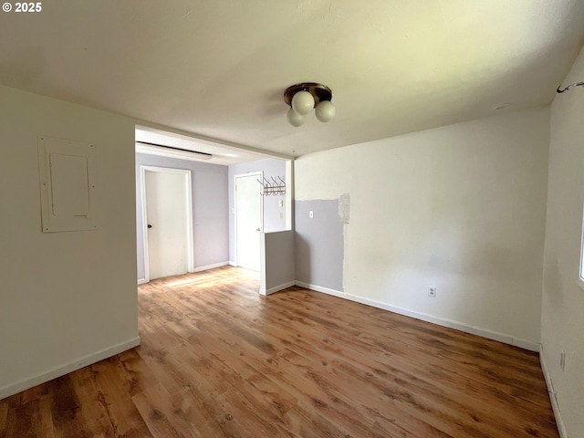 1042 Fir Ave, Reedsport, OR 97467 - spare room with electric panel and wood finished floors
