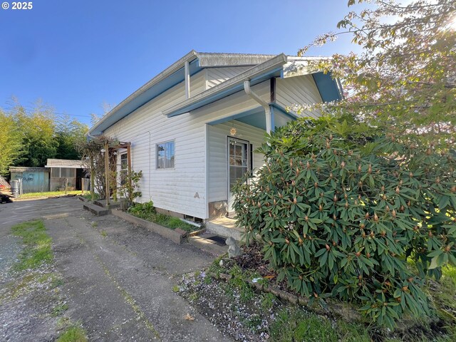 view of home's exterior featuring asphalt driveway