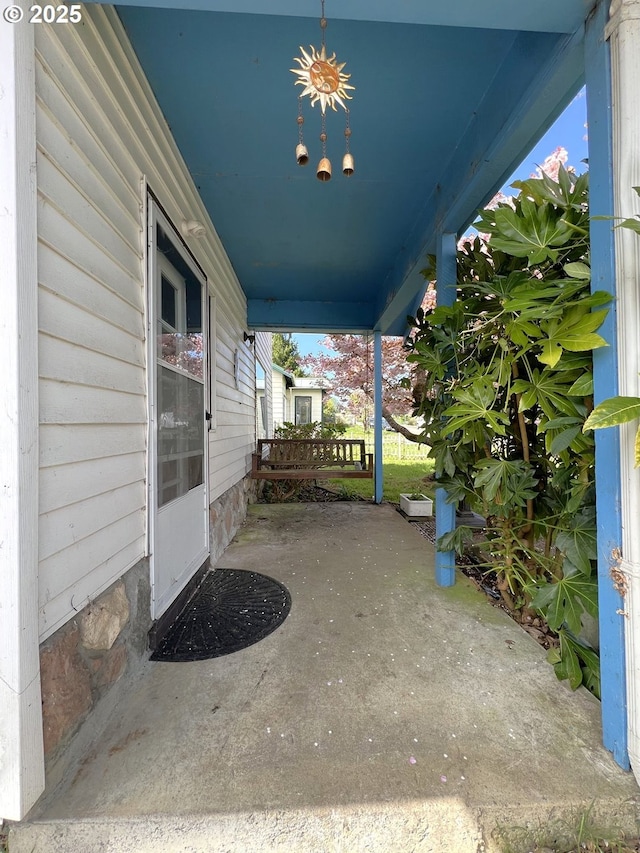 view of patio / terrace with a porch and a carport