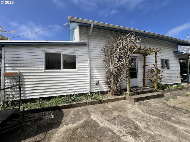 back of property with a pergola