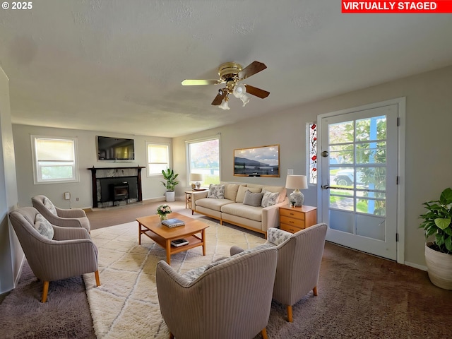 1042 Fir Ave, Reedsport, OR 97467 - living room with ceiling fan, carpet flooring, and a fireplace
