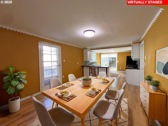 1042 Fir Ave, Reedsport, OR 97467 - dining area with light wood-style flooring and crown molding