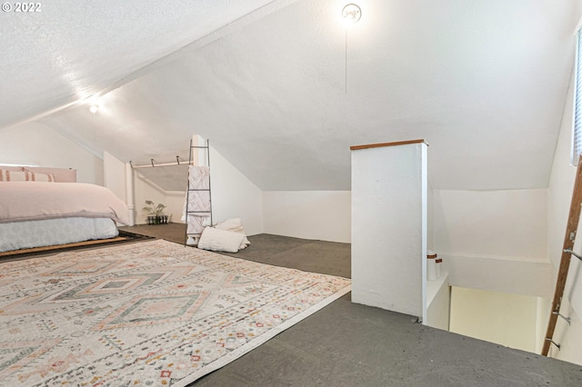 bedroom with dark colored carpet, vaulted ceiling, and a textured ceiling