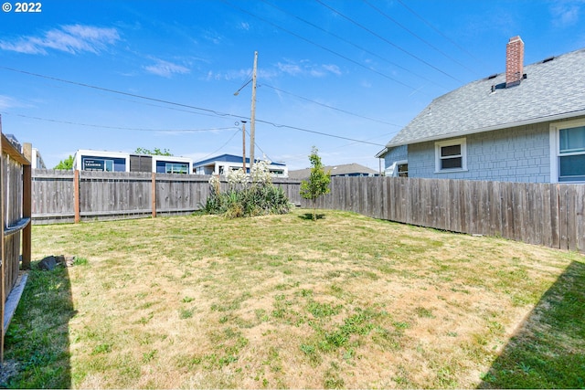 view of yard with a fenced backyard