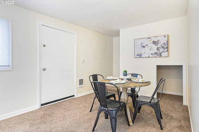 dining area featuring carpet floors, visible vents, and baseboards