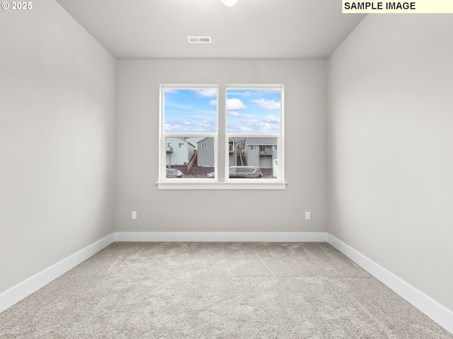 carpeted empty room with baseboards and visible vents