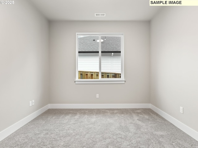 carpeted empty room with visible vents and baseboards