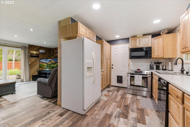 22260 E Wild Fern Ln, Brightwood, OR 97011 - kitchen with stainless steel electric range oven, white refrigerator with ice dispenser, light brown cabinetry, black microwave, and a sink