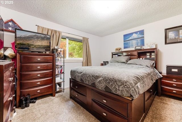 bedroom with light carpet and a textured ceiling