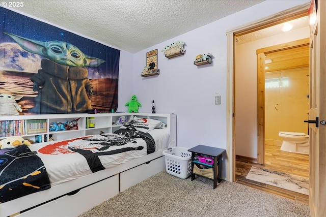bedroom with a textured ceiling and carpet