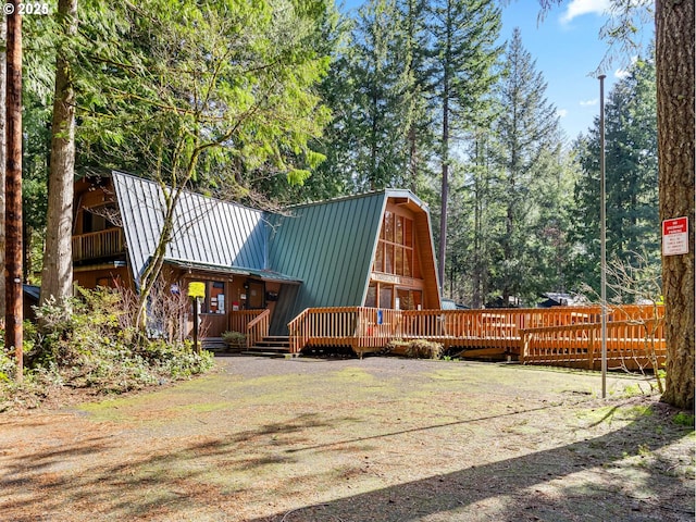 22260 E Wild Fern Ln, Brightwood, OR 97011 - rear view of house with a gambrel roof, metal roof, a wooden deck, and a standing seam roof