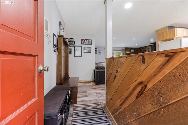 hallway with wood finished floors and recessed lighting