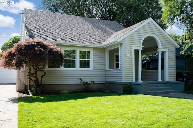 7327 N Washburne Ave, Portland, OR 97217 - view of front facade featuring a shingled roof, a front lawn, driveway, and a porch