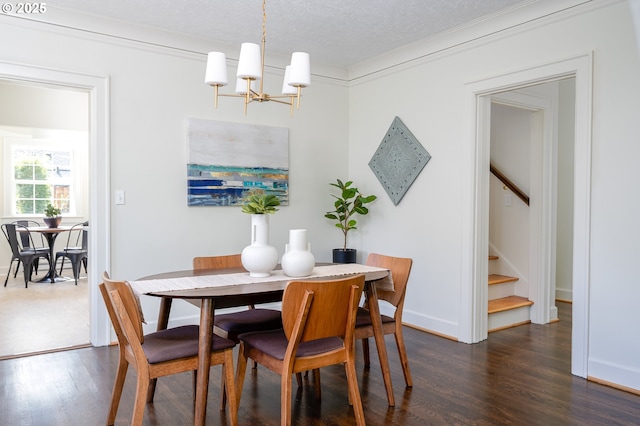 7327 N Washburne Ave, Portland, OR 97217 - dining space featuring a chandelier, stairs, dark wood-type flooring, ornamental molding, and a textured ceiling