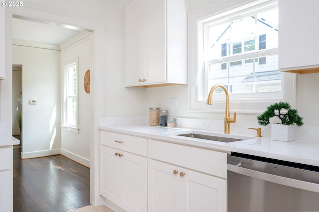 7327 N Washburne Ave, Portland, OR 97217 - kitchen featuring dishwasher, a sink, white cabinets, wood finished floors, and light countertops
