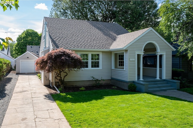 7327 N Washburne Ave, Portland, OR 97217 - view of front of house with roof with shingles, a garage, an outdoor structure, concrete driveway, and a front yard