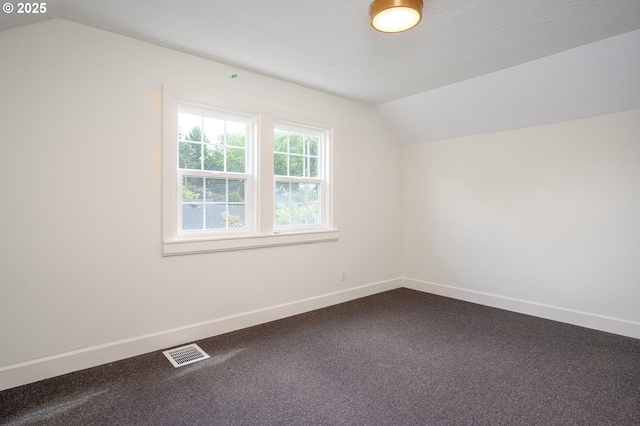 7327 N Washburne Ave, Portland, OR 97217 - additional living space featuring vaulted ceiling, baseboards, and dark carpet