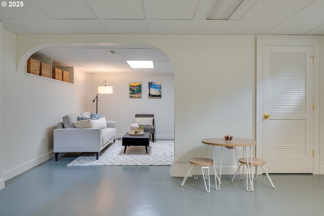 7327 N Washburne Ave, Portland, OR 97217 - sitting room featuring finished concrete flooring, baseboards, and a drop ceiling