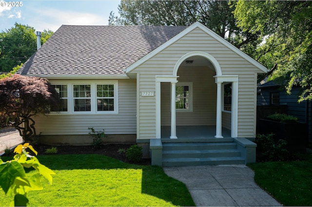 7327 N Washburne Ave, Portland, OR 97217 - view of front of home featuring a front yard, covered porch, and roof with shingles