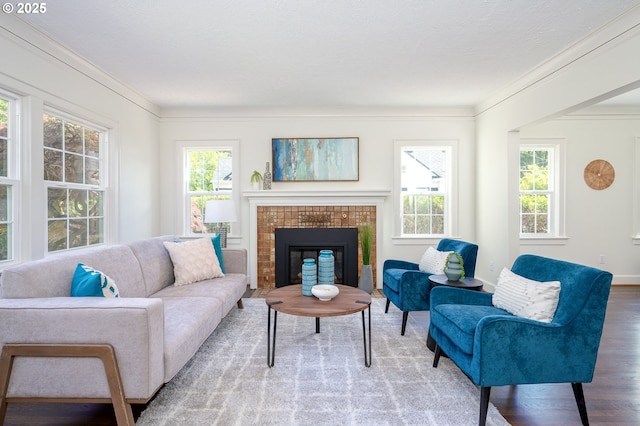 7327 N Washburne Ave, Portland, OR 97217 - living area with crown molding, wood finished floors, a fireplace, and baseboards