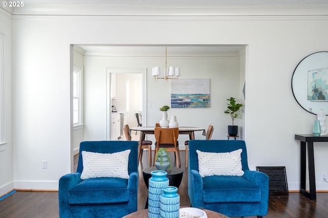 7327 N Washburne Ave, Portland, OR 97217 - living area featuring wood finished floors, a chandelier, baseboards, and crown molding