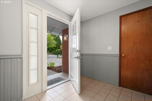 4603 SE 16th Ct, Gresham, OR 97080 - foyer entrance featuring a wainscoted wall and light tile patterned flooring
