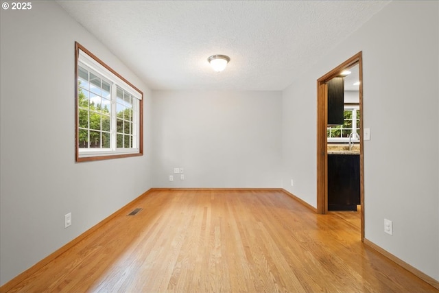4603 SE 16th Ct, Gresham, OR 97080 - spare room with wood finished floors and a textured ceiling