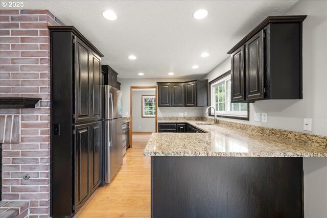 4603 SE 16th Ct, Gresham, OR 97080 - kitchen with light wood-style floors, a peninsula, recessed lighting, light stone countertops, and freestanding refrigerator