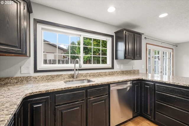 4603 SE 16th Ct, Gresham, OR 97080 - kitchen featuring stainless steel dishwasher, a textured ceiling, recessed lighting, light stone countertops, and light wood-type flooring