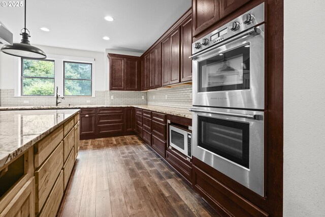 39665 SE Rude Rd, Sandy, OR 97055 - kitchen featuring stainless steel appliances, a sink, tasteful backsplash, light stone counters, and recessed lighting