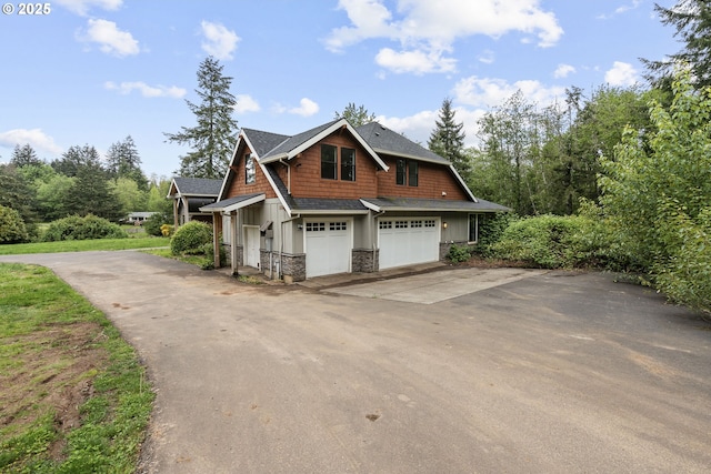 39665 SE Rude Rd, Sandy, OR 97055 - view of side of property with driveway, stone siding, an attached garage, and board and batten siding