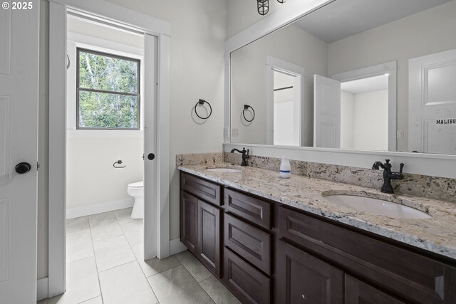 39665 SE Rude Rd, Sandy, OR 97055 - bathroom with toilet, double vanity, tile patterned floors, and baseboards