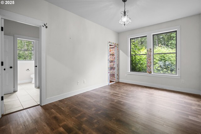 39665 SE Rude Rd, Sandy, OR 97055 - spare room featuring wood finished floors, a chandelier, and baseboards