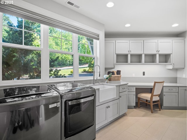 13848 SE Diamond Ridge Rd, Happy Valley, OR 97086 - laundry area with washer and clothes dryer, healthy amount of natural light, light tile patterned floors, recessed lighting, and a desk