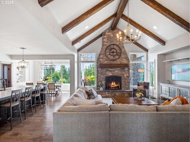 13848 SE Diamond Ridge Rd, Happy Valley, OR 97086 - living room with a chandelier, dark wood-style flooring, beamed ceiling, a stone fireplace, and recessed lighting