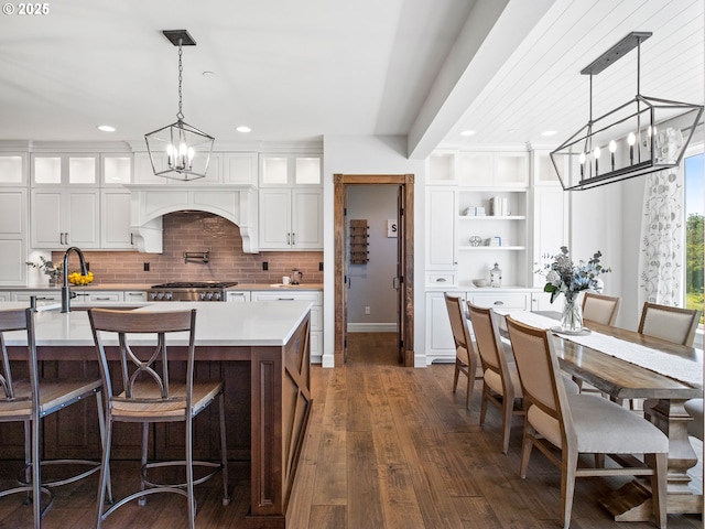 13848 SE Diamond Ridge Rd, Happy Valley, OR 97086 - kitchen featuring a chandelier, open shelves, light countertops, dark wood-style flooring, and white cabinetry