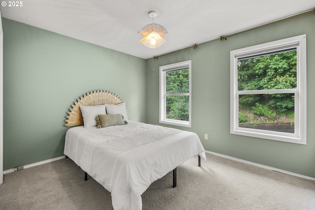 bedroom with carpet and baseboards