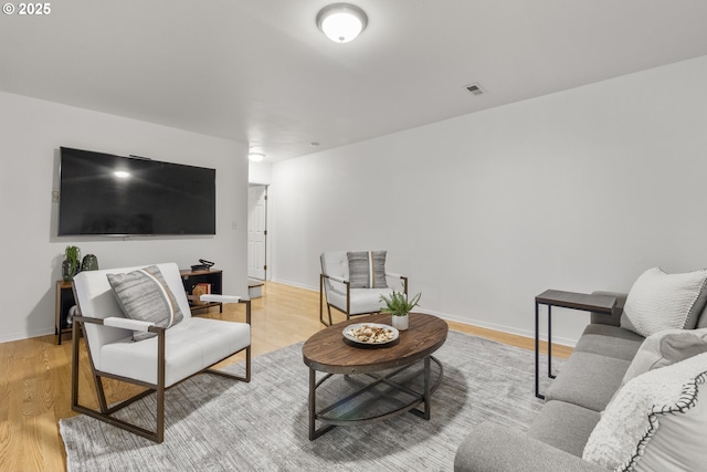 living room with light wood finished floors and baseboards