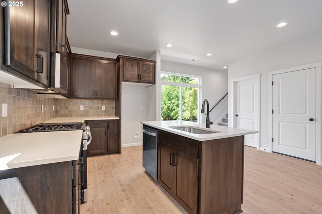 195 SE Acacia Dr, Gresham, OR 97080 - kitchen with appliances with stainless steel finishes, light wood-style flooring, dark brown cabinets, and recessed lighting
