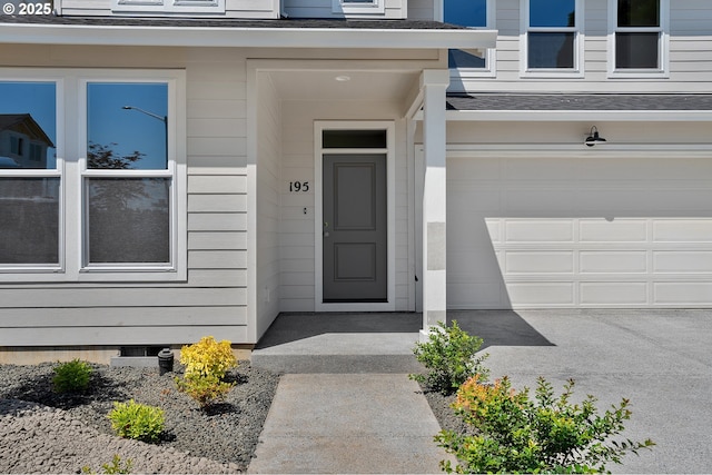195 SE Acacia Dr, Gresham, OR 97080 - view of exterior entry with a garage and roof with shingles