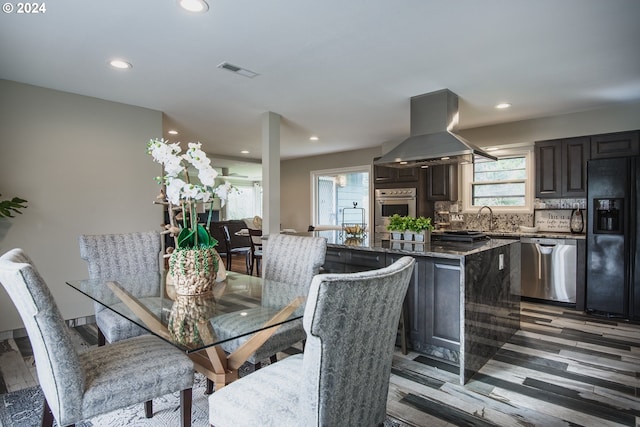 dining space featuring recessed lighting, visible vents, a wealth of natural light, and wood finished floors