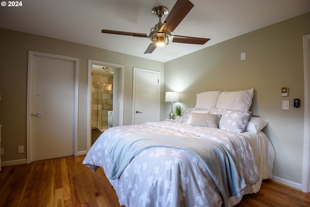 bedroom featuring a ceiling fan, baseboards, wood finished floors, and ensuite bathroom