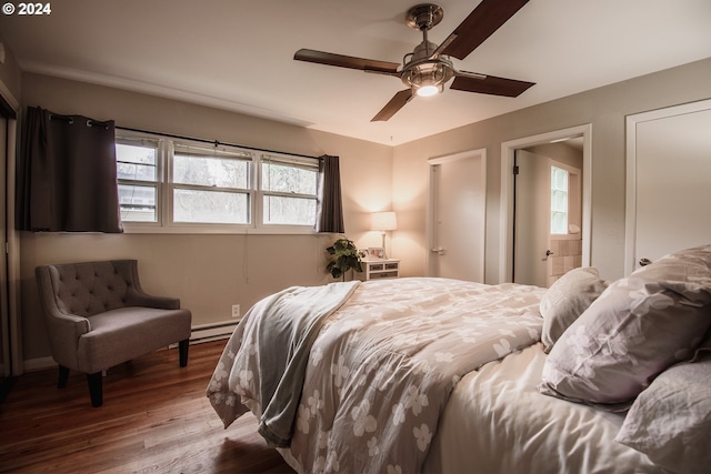 bedroom featuring a baseboard heating unit, ceiling fan, and wood finished floors