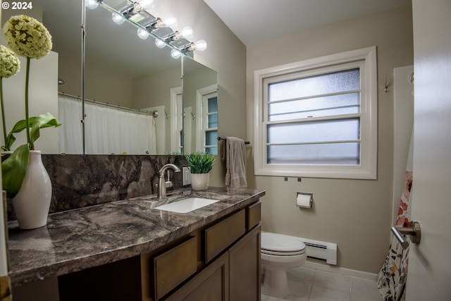 bathroom with a baseboard radiator, vanity, toilet, and tile patterned floors