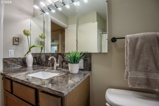 bathroom featuring toilet and vanity